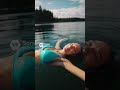 A cute Finnish woman swims by a quiet lakeside!