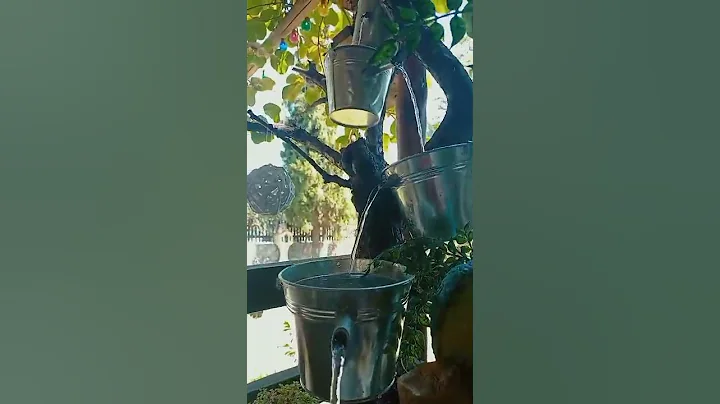 homemade water fountain with tin buckets