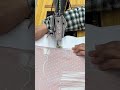 Sewing Intricate White Floral Patterns Onto A Pink Fabric Using A Vintage Manual Sewing Machine Sewing Intricate White Floral Patterns Onto A Pink Fabric Using A Vintage Manual Sewing Machine