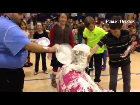 Hamilton Heights Elem. Principal Brian Hostetler gets hit with silly string at Kindness Challenge. #