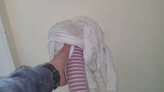 Blowing insulation into a wall through lath and plaster