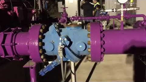 Tilted disc check valve + surge tank