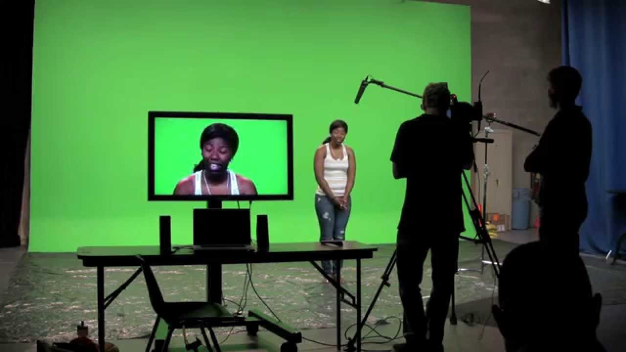 A girl acting in front of a green screen