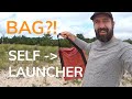 Self launching kite with bag anchor