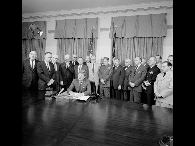 October 2, 1963 - President John F. Kennedy Signing the Uniformed