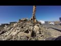 Case CX240 Excavator Loading a Peterson 4700B Horizontal Grinder