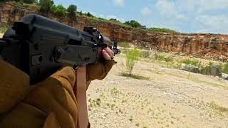Live fire drill with AR and AK at quarry gun range POV