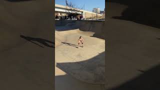 Girl rides roller skates up ramp at skatepark then flips and lands on her head