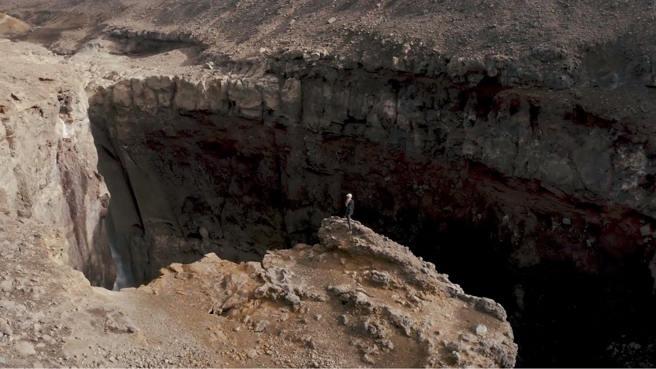 Woman Standing on the Edge of a Cliff