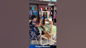 Weaving fabric on a loom: woman weaving fabric on a loom