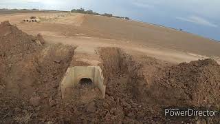 VOLVO EXCAVATOR REMOVING CEMENT STRUCTURES  ON ROADWAY