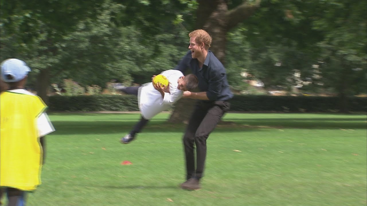 Playful Prince Harry joins in children's handball game