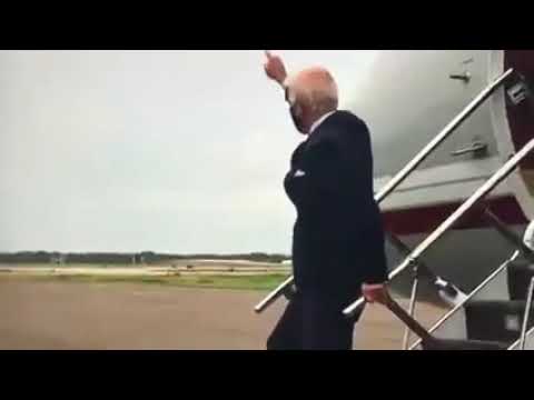 Joe Biden walks off the plane and waves to no one