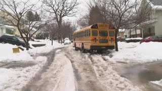 Akron school bus stuck on icy, snow-covered street