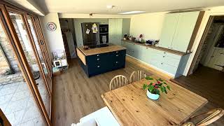 Contemporary kitchen extension with large windows and oak aluminium bi-fold doors in Castlethorpe