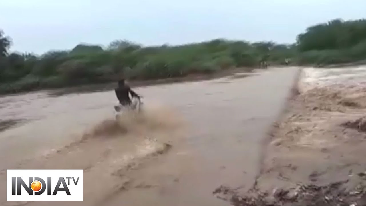 Bravery of biker swept away while trying to cross flooded river in Bhavnagar