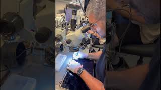 Celebrity Repairing a MacBook screen flex under microscope. This is when a screen has lines or is distorted. Profile