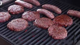 grilling brats and hamburgers on a charcoal grill Char-Griller
