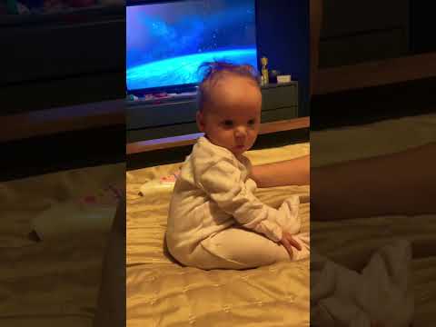 Cute baby girl sitting up on her own baby milestone