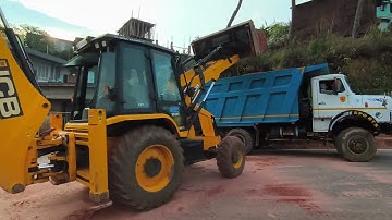 jcb loading soil into a dump truck