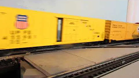 GTW 6252 speeding with a train that has Union Pacific, Santa Fe mechanical refrigerator cars