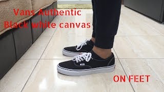 black and white vans on feet