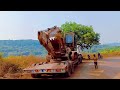 Excavator machine loading and unloading on the trailer  