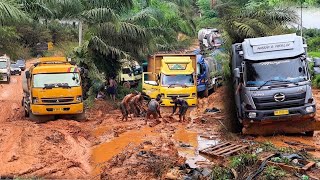DARING DRIVERS TACKLING A SLIPPERY, MUD-FILLED INCLINE