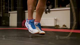 Young Man Skipping Rope Indoors. Man Jumping Rope At The Gym. Male Boxer Legs Jumps Rope. Low