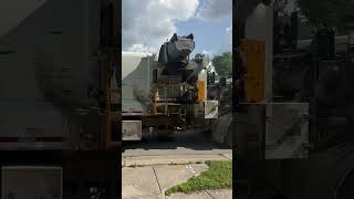 Indianapolis Labrie side loader garbage truck dumping a new Toter