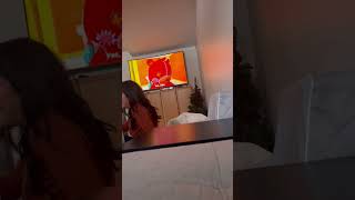 Woman does handstand on living room while TV is playing cartoons then she falls on little girl