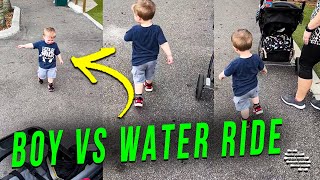 Little Boy Runs From a Water Ride Nearby as Mom Tries to Explain to Him
