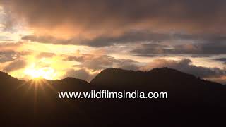 Timelapse of a sunset behind mountains with monsoon clouds