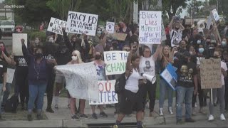 People peacefully protest in solidarity with minneapolis. police help
block cars from roadways so could march down streets tra...