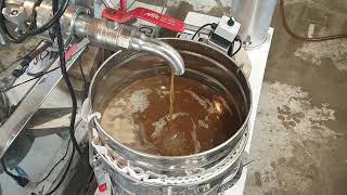 Drawing finished maple syrup off the evaporator. Kemptville, Ontario. March 15, 2025