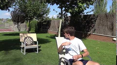 Guy Hits The Bullseye Throwing Dart Shot Backwards
