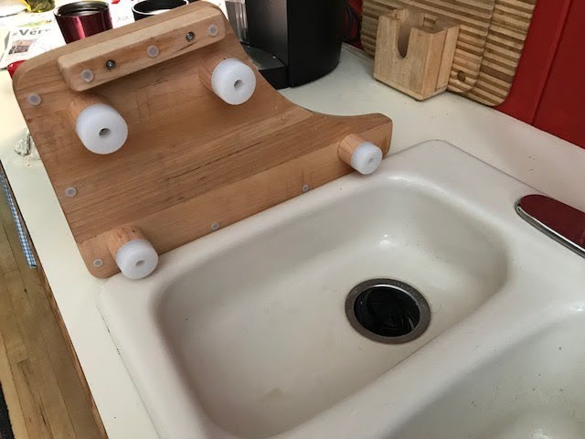 stainless kitchen sink with cutting board