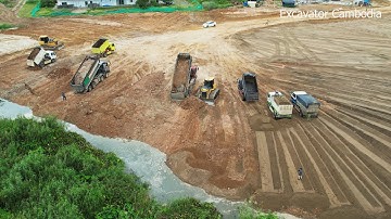 Power Shantui Dozer working pushing soil   China Dump Truck Working Unloading Soil Filling Up