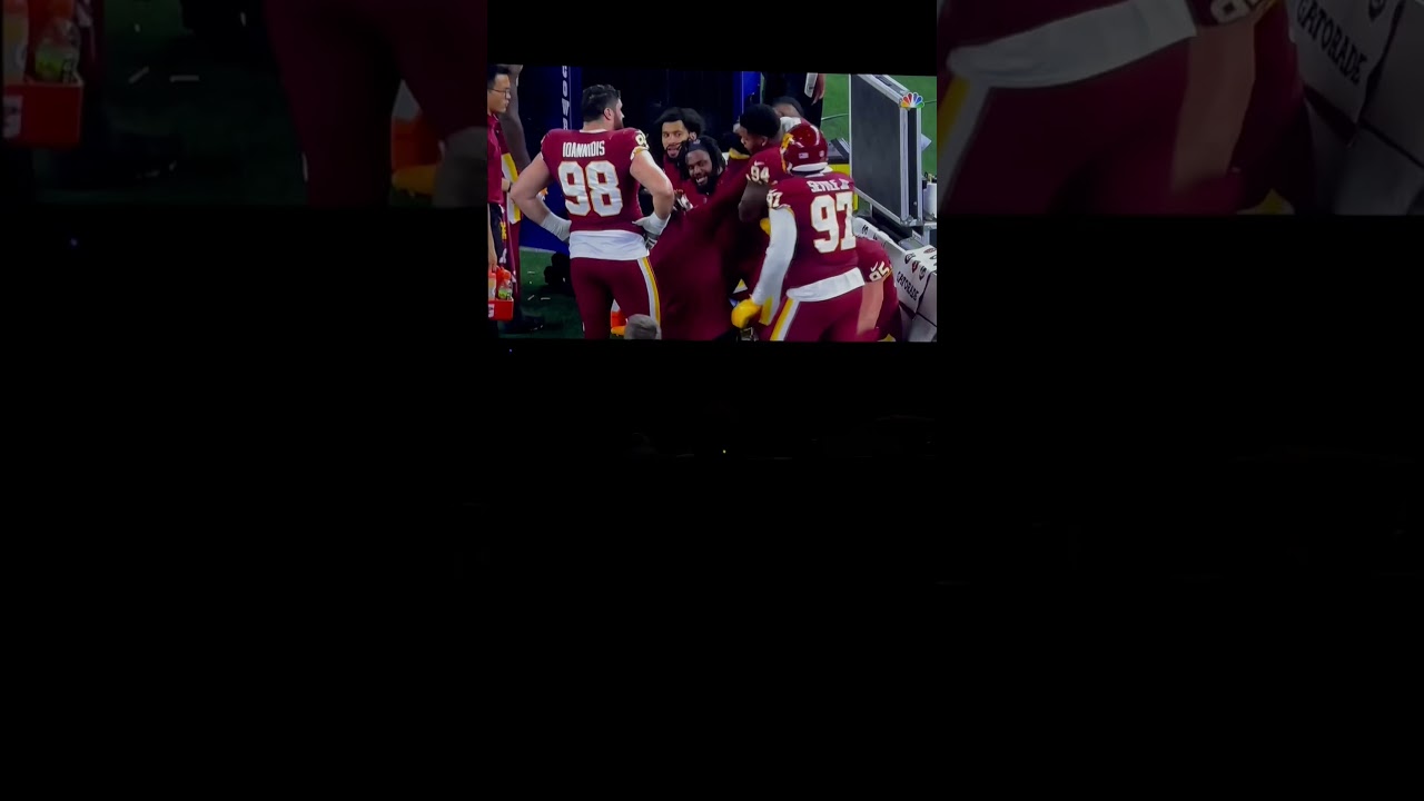 Washington Football Team Jonathan Allen and Daron Payne exchange gifts on sideline