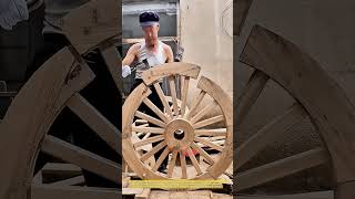 Precision Woodworking Skill: Professional Craftsman Manually Assembling a Wooden Wheel