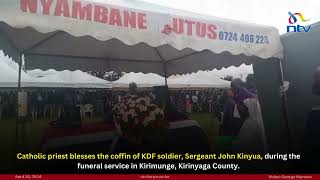 Catholic priest blesses the coffin of KDF soldier, Sergeant John Kinyua, during the funeral service