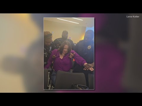 Mother carried out of school board meeting