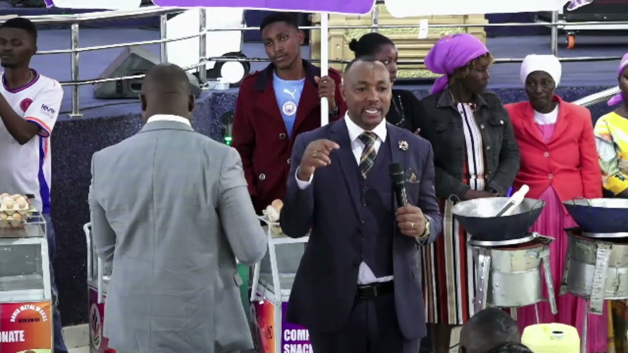 Bishop Ben of JCM gives 10 pikipiki,30 trolleys and 10 bales of clothes to 50 people 