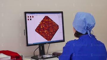 Female Scientist Looking On Computer Screen In Lab. Scientist working with computer in lab