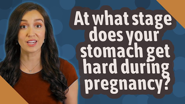 When does a pregnant woman stomach start to get hard