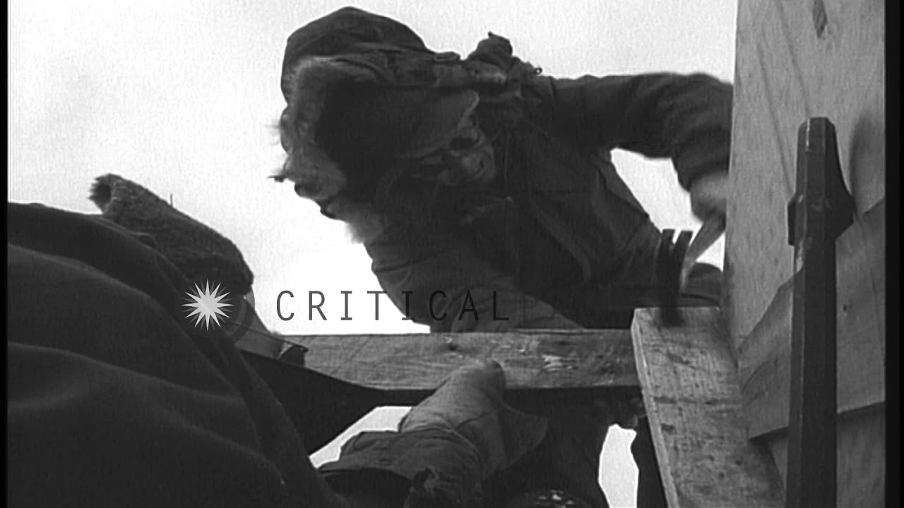 Men dressed in winter clothing construct supply shaft Sierra, Greenland. HD Stock Footage