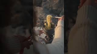 A Person Cooking Noodles On A Backpacking Stove -1997