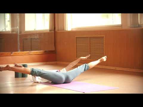 Woman doing yoga on a mat on the floor