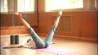 Woman doing yoga on a mat on the floor