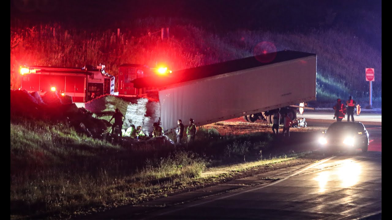 VIDEO: Semi driver injured after load falls on top of him after
